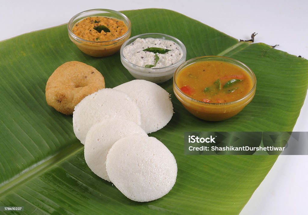 food South Indian food idli vada with sambar on a banana leaf