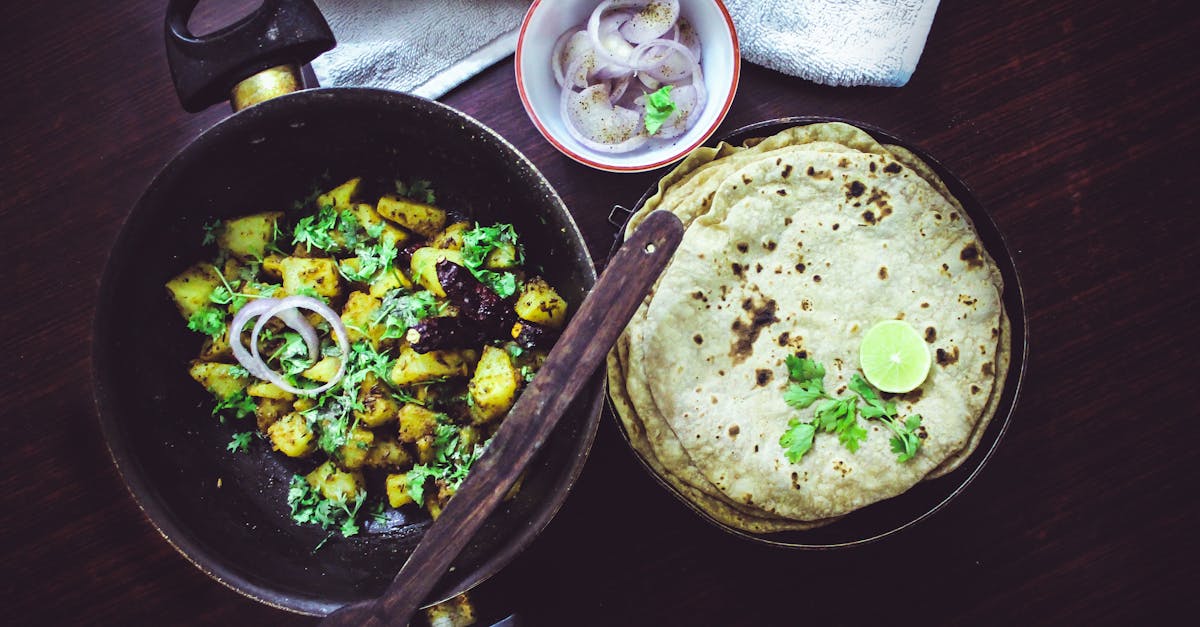 Bangalore-style home-cooked meal featuring roti, aloo fry, and fresh onions.