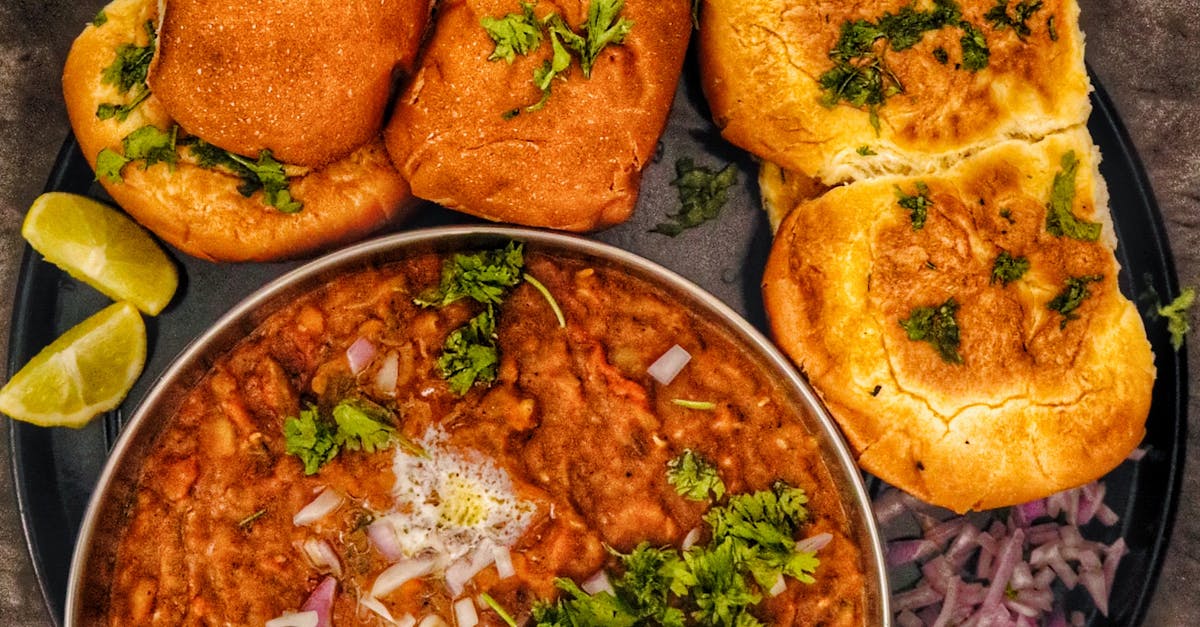 A delectable top view of authentic Indian Pav Bhaji garnished with onions, lime, and cilantro.